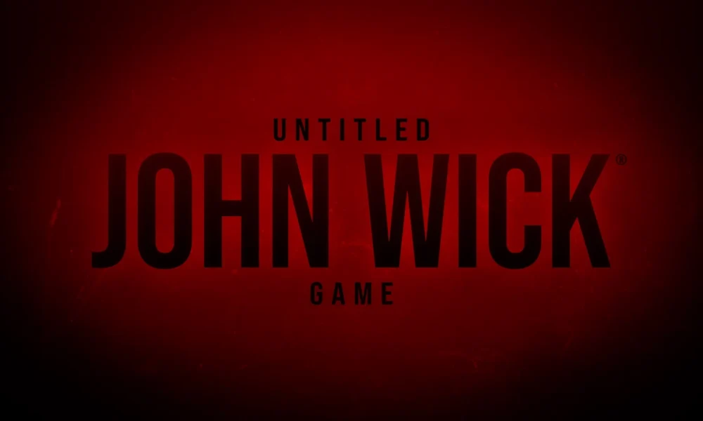 John Wick in a black suit aiming a pistol down a gold Continental hallway, official art for Saber Interactive’s untitled John Wick video game