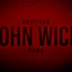 John Wick in a black suit aiming a pistol down a gold Continental hallway, official art for Saber Interactive’s untitled John Wick video game